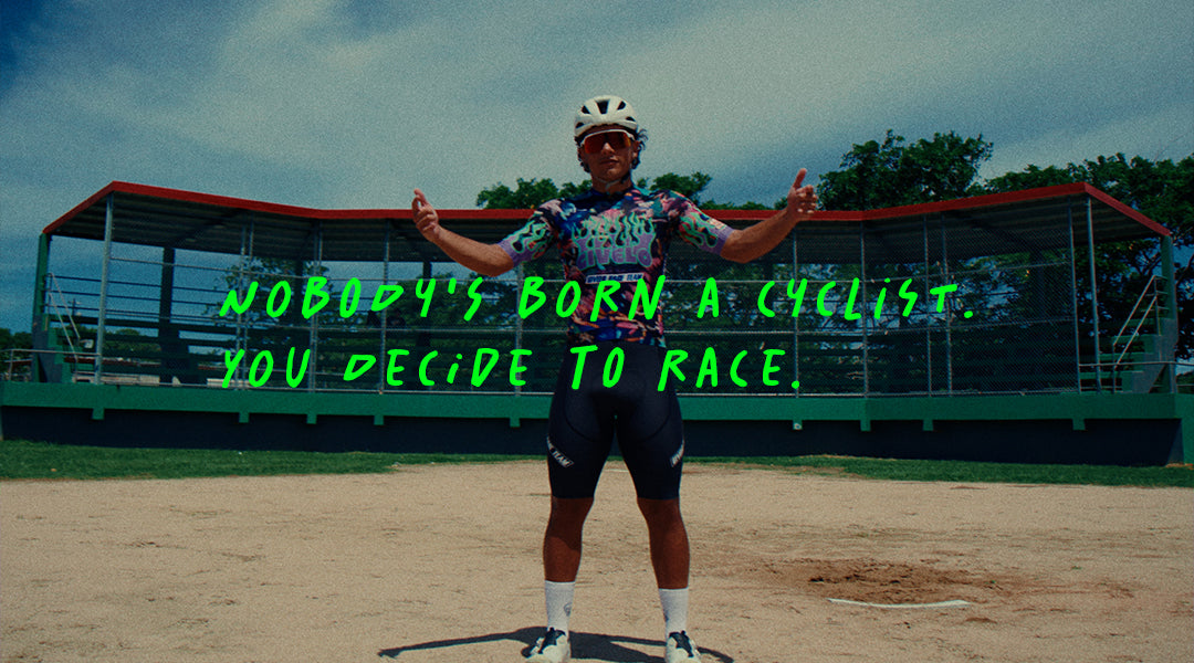 Ciclista del GVL Race Team en un campo de béisbol en Puerto Rico con el texto Nobody's born a cyclist. You decide to race.